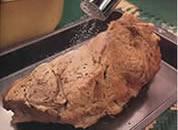 Image shows  dry baked joint of meat in baking tray