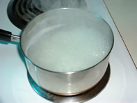Image showing rice boiling in pan of water