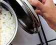 An image of rice being cooked using boiling method