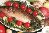 Baked fish served with garnish and baby tomatoes