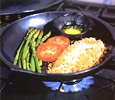 fish and vegetables being shallow fried