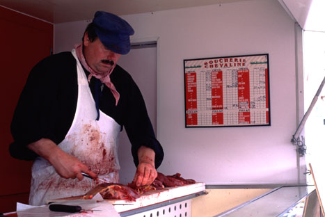 An image showing butcher handling meat