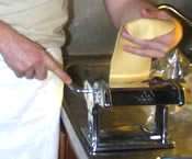 An image of pasta preparation using a pasta machine