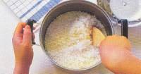 An image of boiled rice being stirred