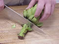 separating the top and bottom of the atichoke